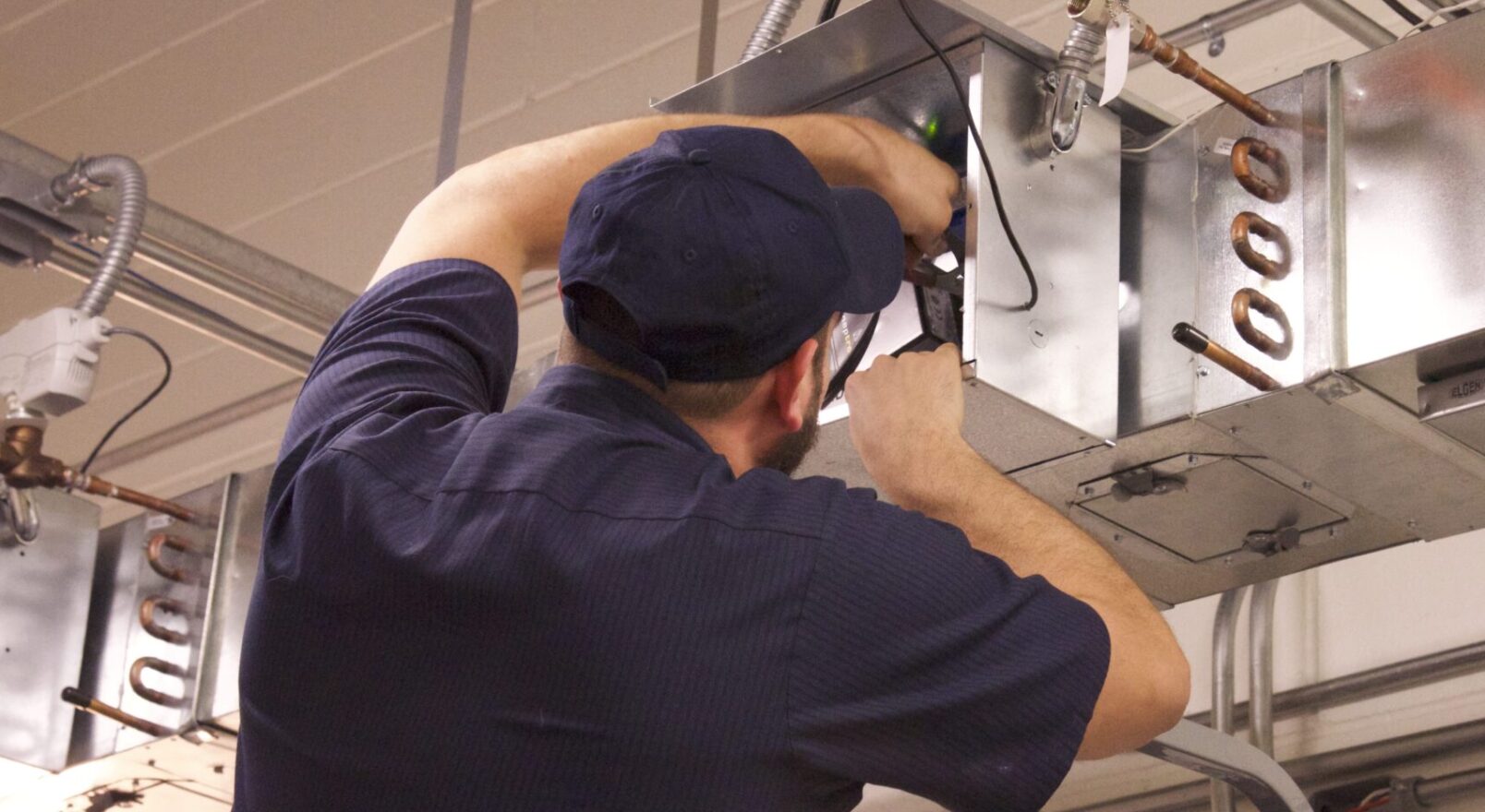 Man working on HVAC equipment